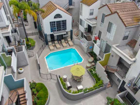 Ariel shot of the center of the apartment community with the swimming pool area surrounded by the apartment buildings. 