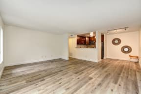 Vacant apartment home located on the first floor with hardwood inspired flooring through out with views of the open concept kitchen and dining area. 