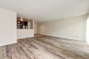Vacant apartment home located on the first floor with hardwood inspired flooring through out with views of the open concept kitchen and front door. 