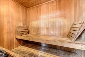 Community sauna with wood paneling through out 