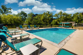 teal lounge chairs by an outdoor pool