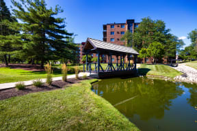 The Bennington Apartments property with a covered bridge over a small body of water