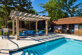 outdoor swimming pool with nearby pergola at The Bennington Apartments