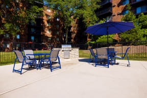 outdoor grilling area with blue dining sets