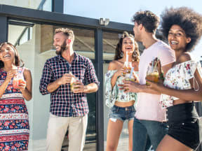 a group of young adults drinking and having fun outside