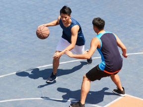People playing basketball on a court