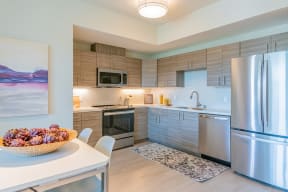 Kitchen area with full size stainless steel appliances