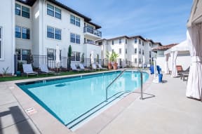 Pool with lounge chairs | Ageno Apartments in Livermore, CA