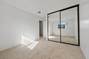 Bedroom with mirrored closet doors 