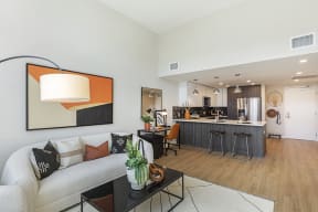 Maxwell Apartments kitchen and living area with stainless steel appliances and modern cabinetry
