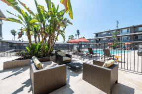 Seating area by pool and BBQ  l Emerald Hills Apartments in Monterey Park