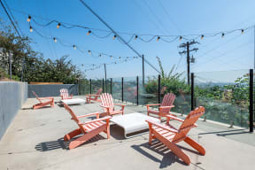 Group of chairs on a deck area  l Emerald Hills Apartments in Monterey Park