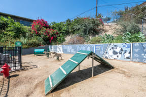 Dog park with play equipment l Emerald Hills Apartments in Monterey Park