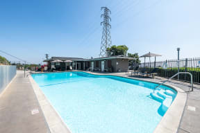Pool with lounge chairs l Emerald Hills Apartments in Monterey Park