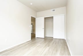 a bedroom with white walls and wood floors at K Street Flats, Berkeley, 94704
