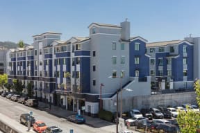 a large blue building with a parking lot in front of it at K Street Flats, Berkeley California