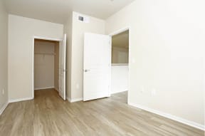 a bedroom with a closet and an open door at K Street Flats, Berkeley