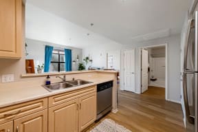 a kitchen with wooden cabinets and a stainless steel sink at K Street Flats, California
