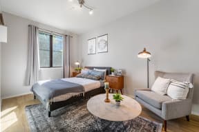 a bedroom with a bed and a chair in a 555 waverly unit at K Street Flats, California