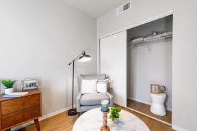 a bedroom with a medium sized bed and a small desk with a chair in front of a at K Street Flats, California