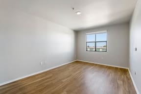 a bedroom with hardwood floors and a window at K Street Flats, California, 94704