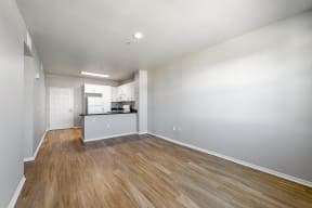 an empty living room with a kitchen in the background at K Street Flats, Berkeley, 94704