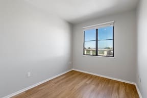 a bedroom with a window and hardwood floors at K Street Flats, Berkeley, 94704