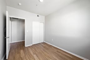 a bedroom with white walls and hardwood floors at K Street Flats, Berkeley California