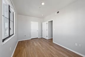 a bedroom with hardwood floors and grey walls at K Street Flats, Berkeley, 94704