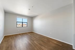 a bedroom with hardwood floors and a window at K Street Flats, Berkeley, CA