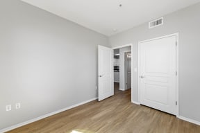 a bedroom with two doors and hardwood floors at K Street Flats, California
