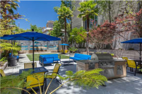a patio with a grill and tables with umbrellas at K Street Flats, Berkeley California