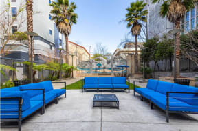 a courtyard with blue couches and a coffee table at K Street Flats, Berkeley, 94704