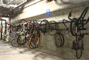 a bunch of bikes are hanging on a wall at K Street Flats, Berkeley California