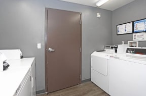 a room with a washer and dryer and a door at K Street Flats, Berkeley, 94704