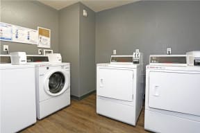 a group of washers and dryers in a room at K Street Flats, California