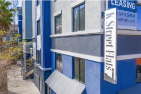 a blue and white building with a sign that reads leasing at K Street Flats, California, 94704