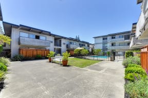 Apartments for Rent Mountain View - Glenwood Garden - Landscape With Paved Walkways, a Bench, and a View of the Pool