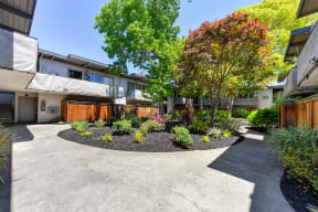 Apartment Mountain View CA - Glenwood Garden - Landscape With Paved Walkways, View of the Building Exterior, and Many Decorative Trees and Bushes