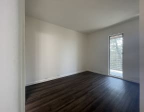 North Oakland CA Apartments for Rent - Spacious Bedroom with Hardwood Floors Featuring a Large Window