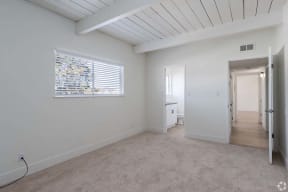 Apartments for Rent in Mountain View - Glenwood Garden - Main Bedroom With Lush Carpet, Windows With Shutters, and an Attached Bathroom