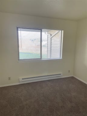 Lake Meridian Shores apartment home bedroom with carpeting and large window