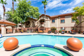 Apartments West Phoenix - Del Mar - Swimming Pool with Jacuzzi, Lounge Chairs, and View of Apartment Homes