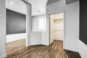 Phoenix Apartments for Rent - Spacious Den with Columned Entry, Wood Flooring, Accent Walls, and a Closet