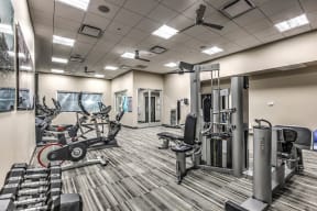 Vantage Lofts Henderson Apartments - Fitness Room With Free Weights, Stationary Bike, and Weight Machines