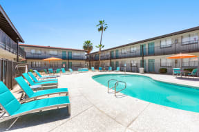 Apartment Phoenix, AZ - Loramont on Thomas Swimming Pool Surrounded by Lounge Chairs and Outdoor Dining Tables