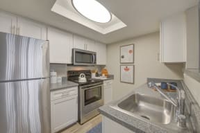 Apartments for Rent in Moreno Valley, CA - Sienna Pointe Kitchen With Stainless Steel Appliances and Modern Wood Cabinets