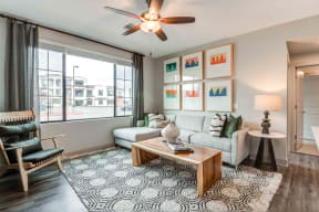 Pet Friendly Apartments in Chandler AZ-The Core Chandler Open Living Room with Large Window with a Great View, Wood Style Floors, and a Refreshing Ceiling Fan
