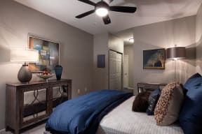 City Place at Westport Fully Furnished Bedroom with Plush Carpet Flooring, Ceiling Fan, and Large Closet