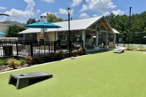 Outdoor Cornhole Area at Reserve at Park Place Apartment Homes, Hattiesburg, MS